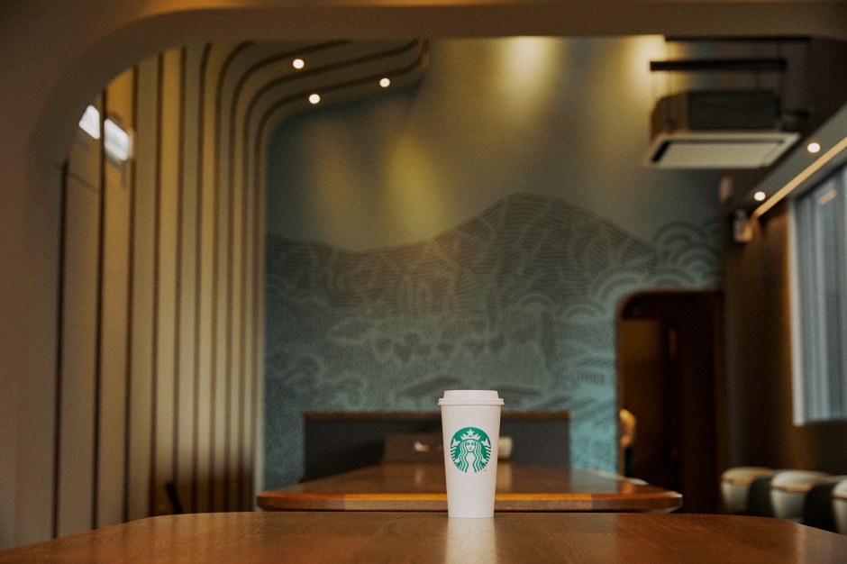 小檔星巴克桃園春日門市星巴克桃園春日門市內裝延伸外觀的弧形意象，在吧檯上方以弧形格柵障板天花及一二樓大幅咖啡莊園壁畫為亮點，邀請顧客在桃園春日門市中享受繁忙城市的清新寧靜 (4)